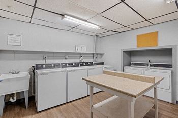 a kitchen with white appliances and a table
